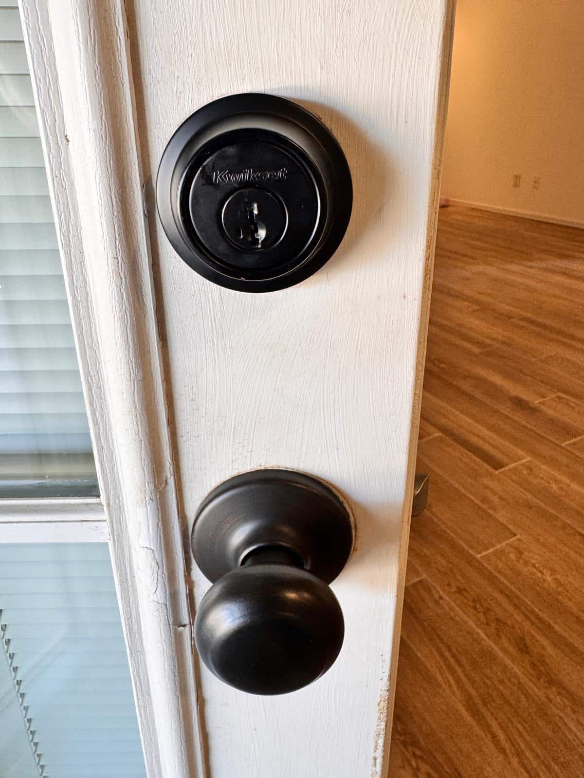 Deadbolt and strike plate aligned on a residential door by C&R Locksmith so the bolt throws fully