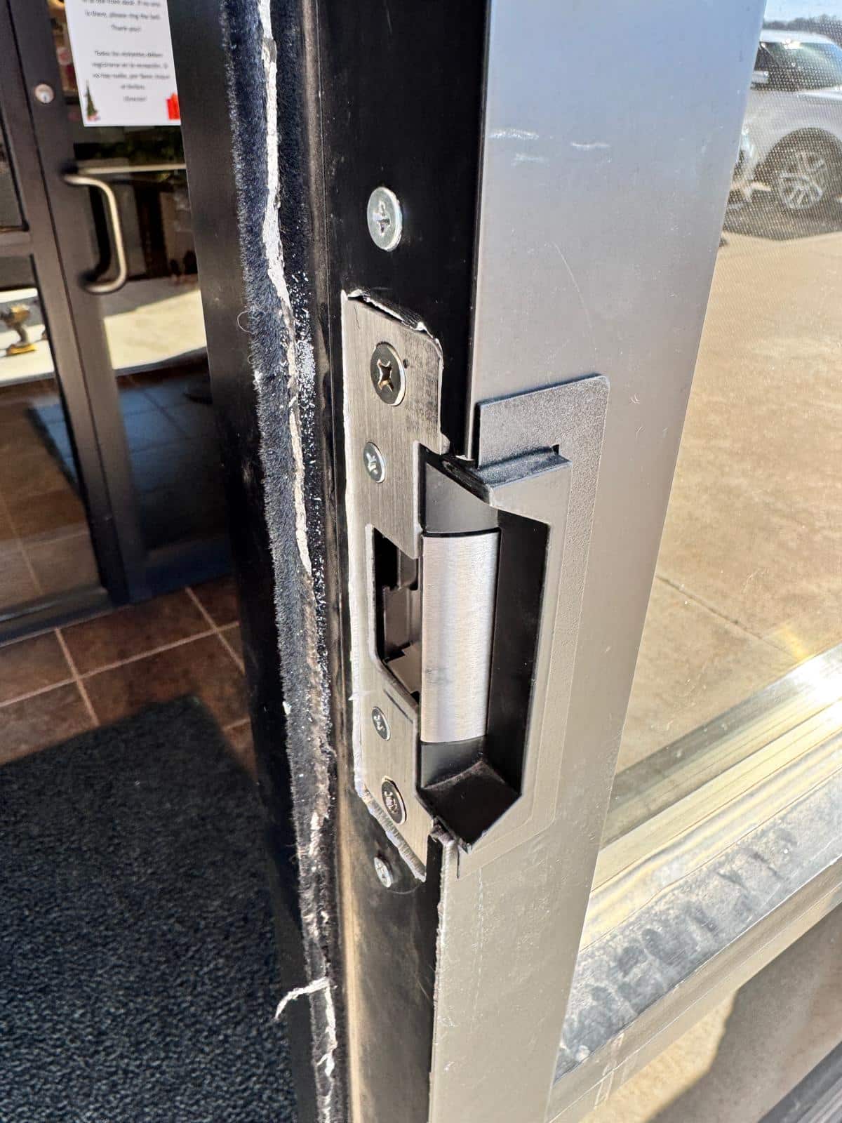 Residential entry door with deadbolt being opened by a licensed locksmith