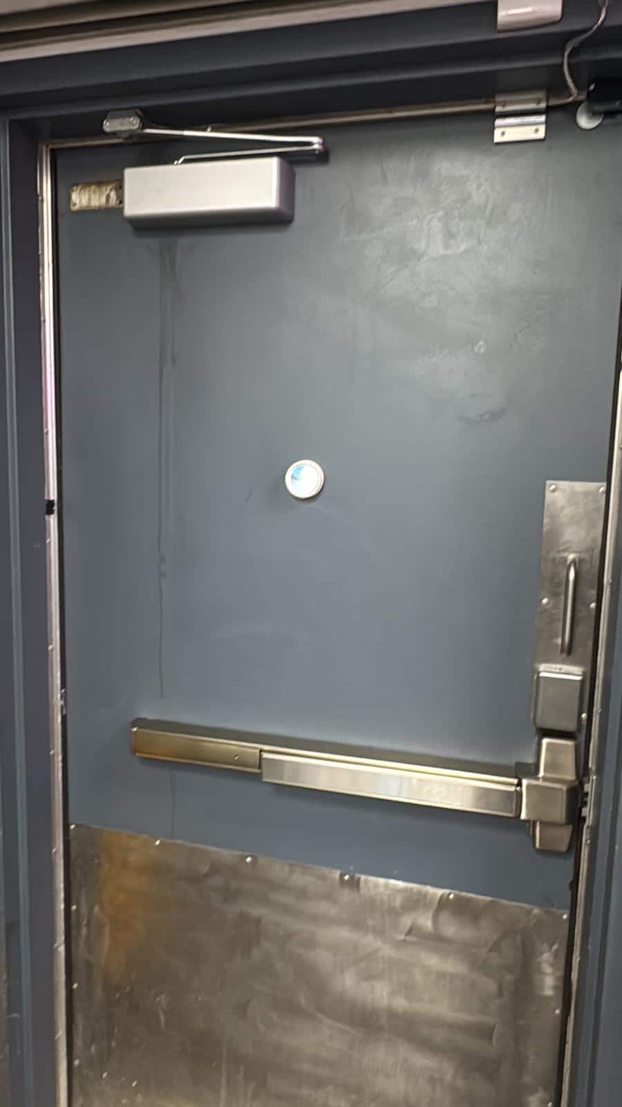 Exit device latch and strike being checked for alignment on a commercial door frame