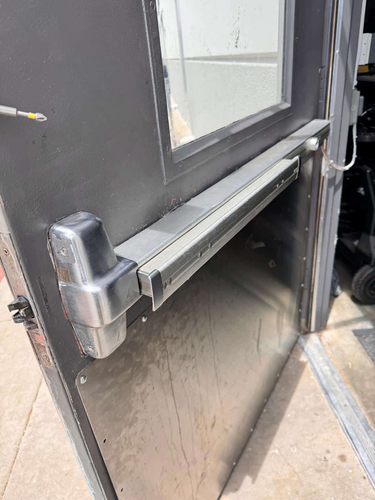 Push bar exit device installed on a commercial rear exit door in Oklahoma City