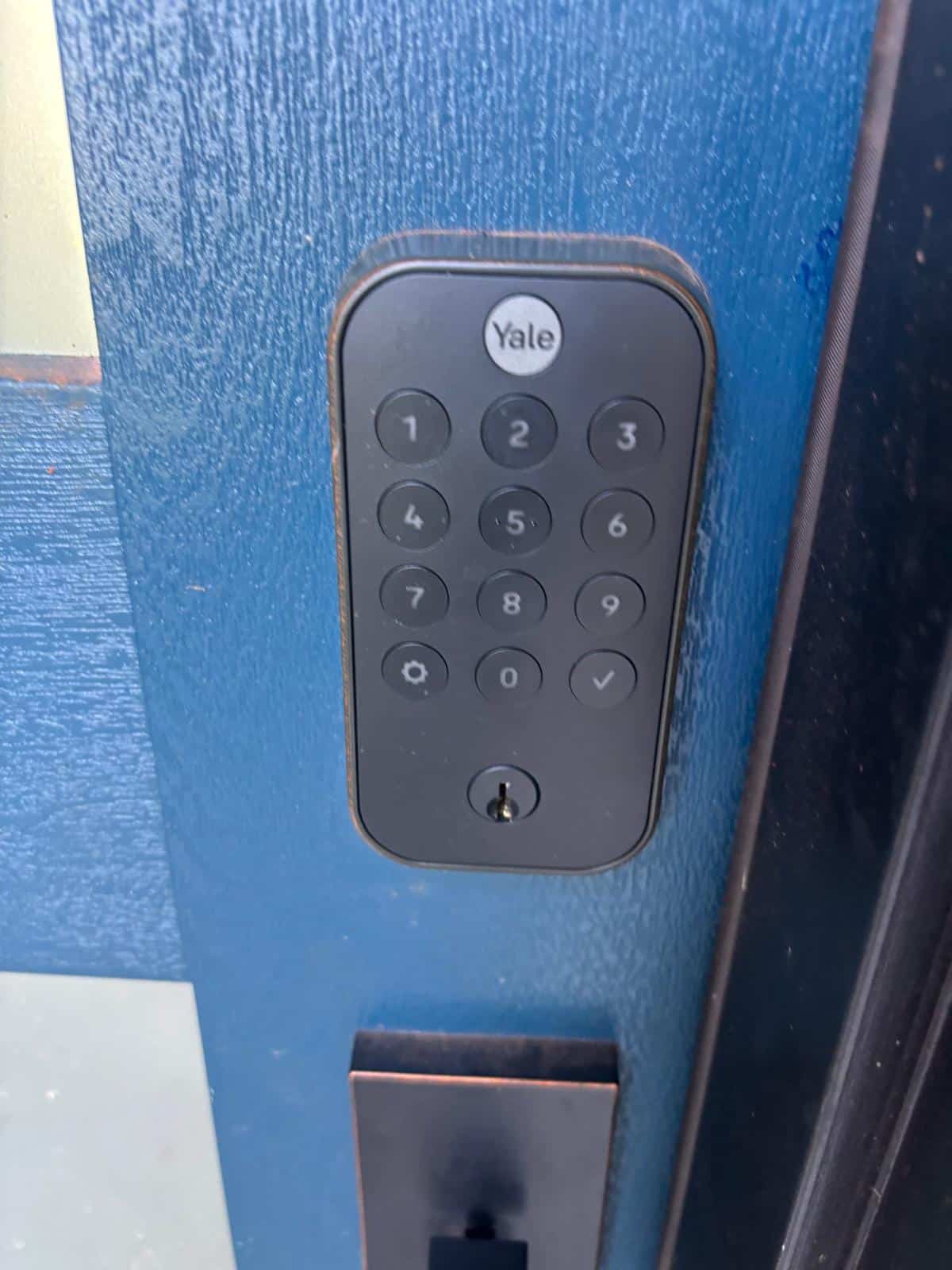 Locksmith working on a locked commercial storefront door in Oklahoma City