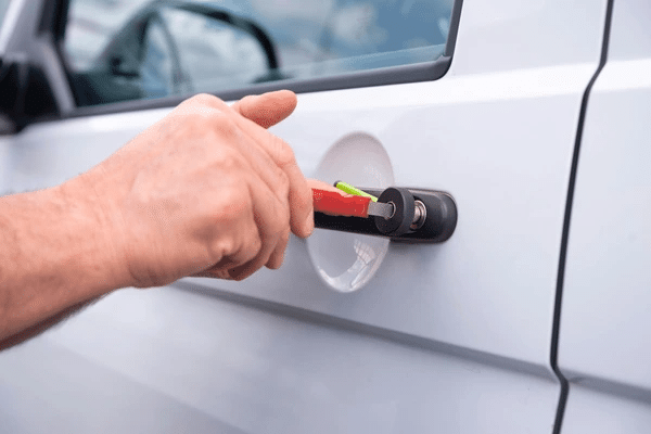 Locksmith opening a locked vehicle door without damage in an Oklahoma City car park