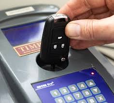 Replacement car key being cut to code at the vehicle in Oklahoma City