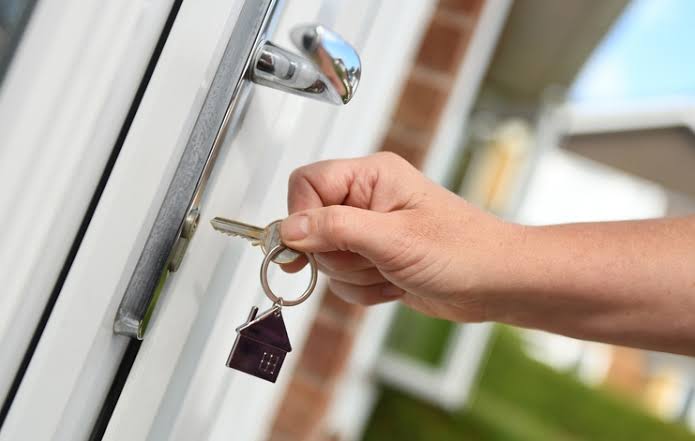 Locksmith rekeying an apartment unit door lock during tenant turnover at an Oklahoma City rental property