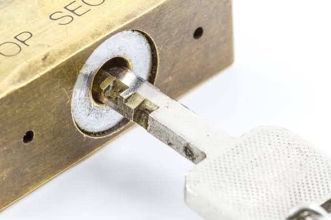 Master key and change keys laid out beside commercial cylinders for an Oklahoma City property