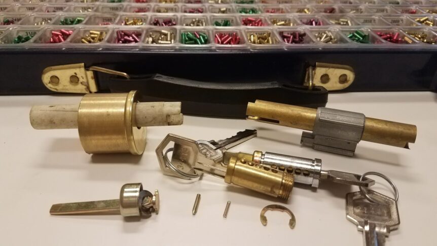 Locksmith rekeying the front door lock of a house in the Oklahoma City metro